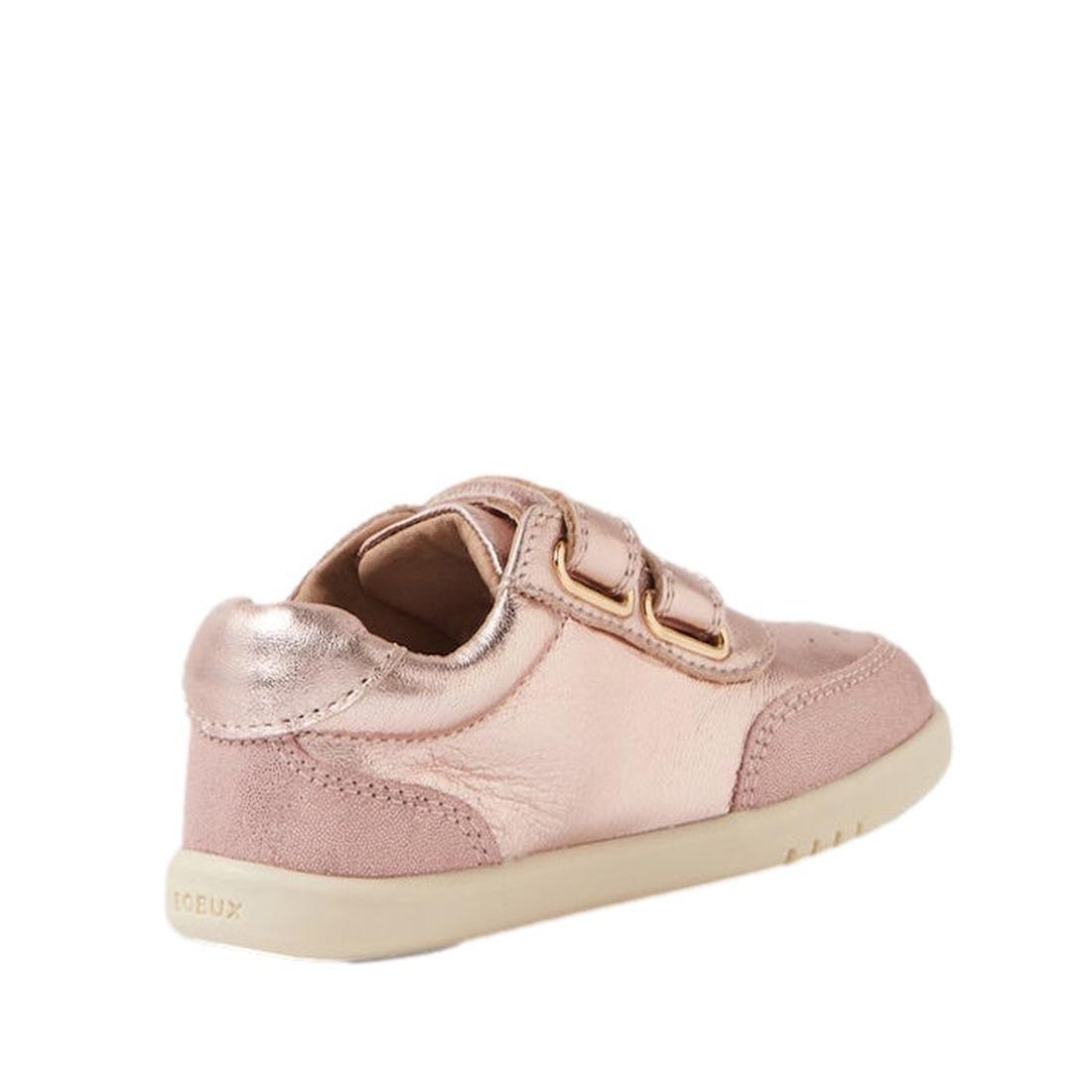 The Bobux Toddlers IWalk IW Champ Sneaker Rose Gold 650510 is a metallic pink unisex kids’ shoe with two hook-and-loop straps and a rubber sole, shown from the back-left side against a white background—a stylish pick for young Champ fans., 9420068552746, 