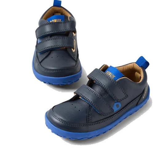 The Bobux IW Iwalk Dawn Toddlers Leather Sneaker Navy Alpha Barefoot features navy blue leather, bright blue soles and toe caps, two hook-and-loop straps, and tan lining—ideal shoes for active toddlers.