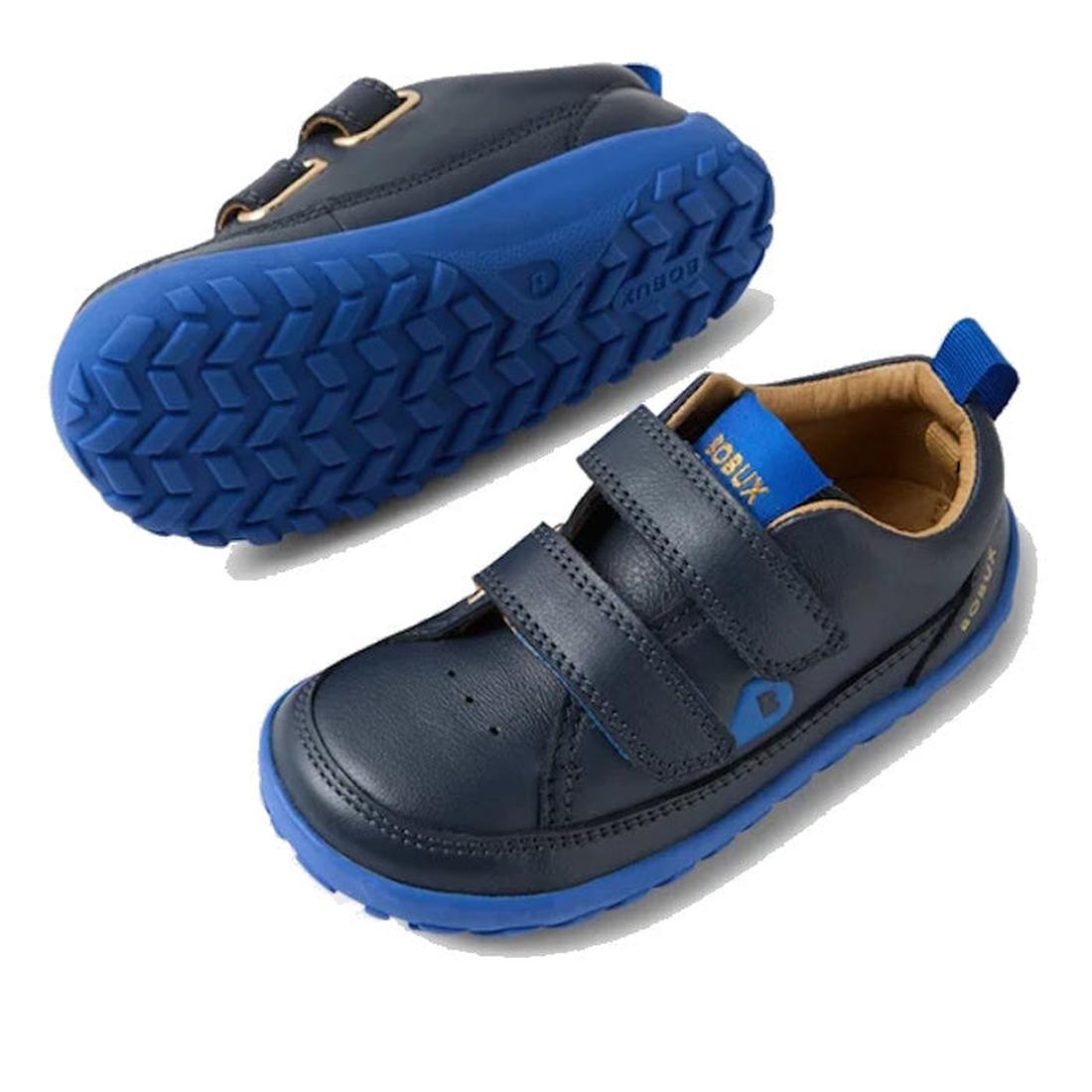 The Bobux IW Iwalk Dawn Toddlers Leather Sneaker Navy Alpha Barefoot is shown in navy blue with blue rubber soles and two velcro straps, displayed from the side and bottom on a white background., 52197, 9420068565289, 9420068565296, 9420068565302, 9420068