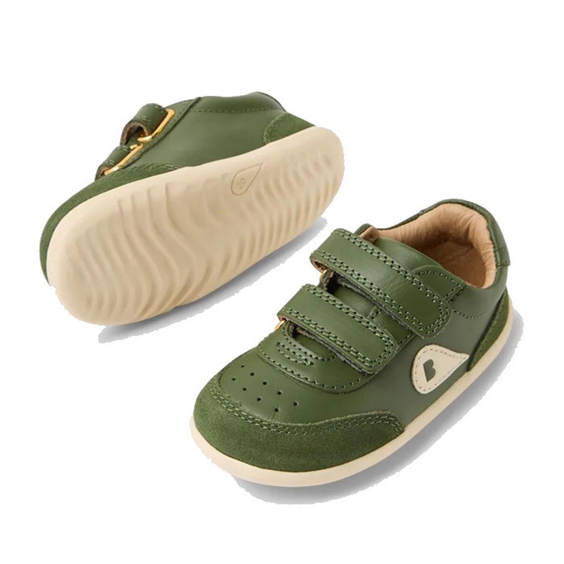 The Bobux Step Up SU Champ II Sneaker in Bronze Green is a pair of toddler leather shoes with beige soles, adjustable hook-and-loop straps, and a small heart detail on the side. One shoe is shown from the top, the other from the sole., 9420074812698, 9420
