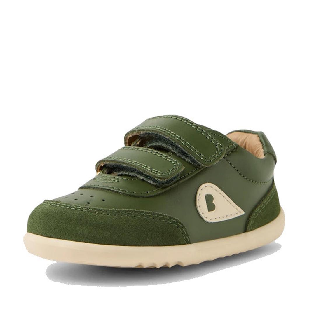 The Bobux Step Up SU Champ II Sneaker in Bronze Green features beige accents, adjustable hook-and-loop straps, a beige sole, perforated toe area, and a decorative side patch with a B logo., 9420074812698, 9420074812704, 9420074812711