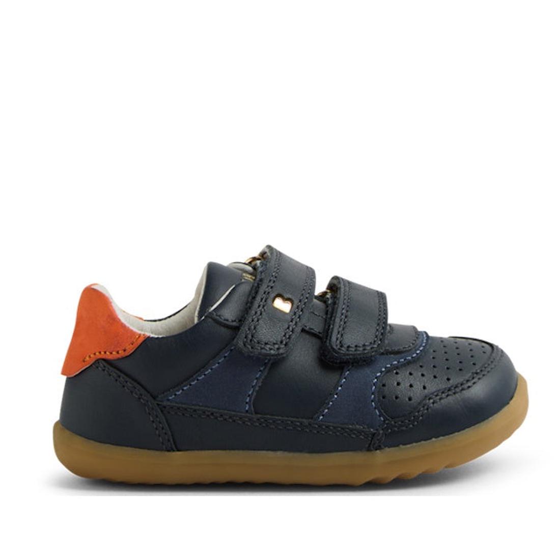 The Bobux SU Step Up Hunter Leather Toddlers Sneaker Navy features navy blue leather, two velcro straps, a tan rubber sole, toe perforations, and an orange heel accent—ideal kids’ sneakers or comfy first walker shoes., 9420074833853, 9420074833860, 942007