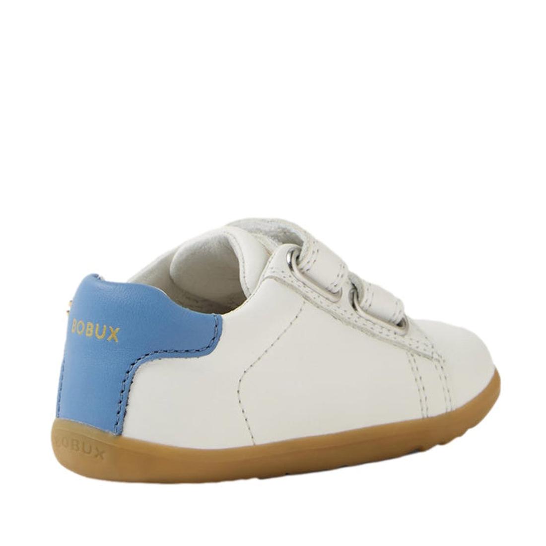 The Bobux SU Step Up Maverick Leather Toddlers Sneaker in White Coronet Blue is a small white leather first walker with a light brown sole, blue heel accent, gold Bobux branding, and two Velcro straps for comfy steps., 9420074836793, 9420074836809, 942007