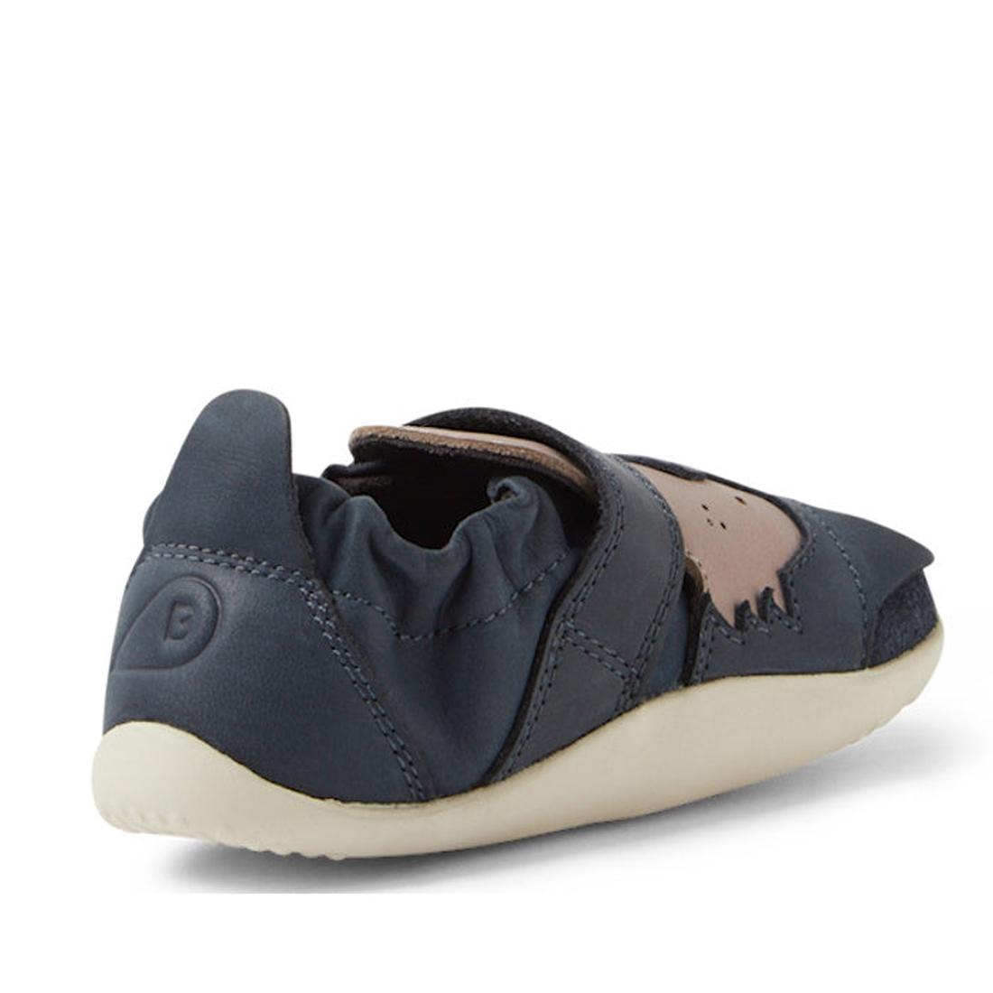 The Bobux XP Xplorer Howl First Walking Shoes Navy feature a dark blue design with an elastic heel, beige sole, and brown animal-shaped side patch, shown from the back and side on a white background., 9420074806000, 9420074806017, 9420074806024, 942007480