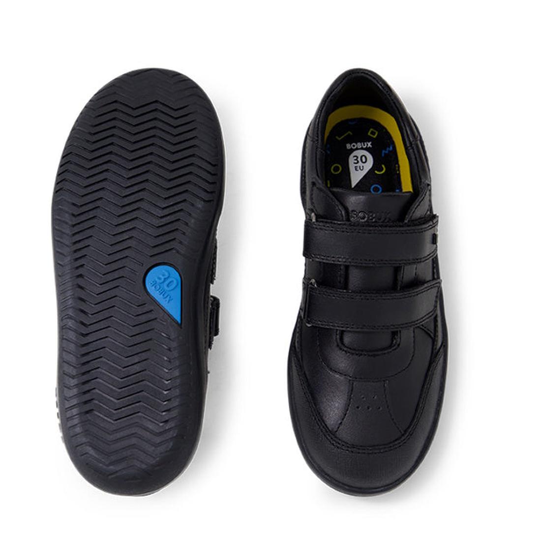 The Bobux Kid+ Black School Leather Shoe Traverse Trainer is a durable kids’ school shoe with two adjustable Velcro straps. One sneaker-style shoe is shown from the top, and the other from the bottom reveals a textured sole with a blue “30” detail., 94200