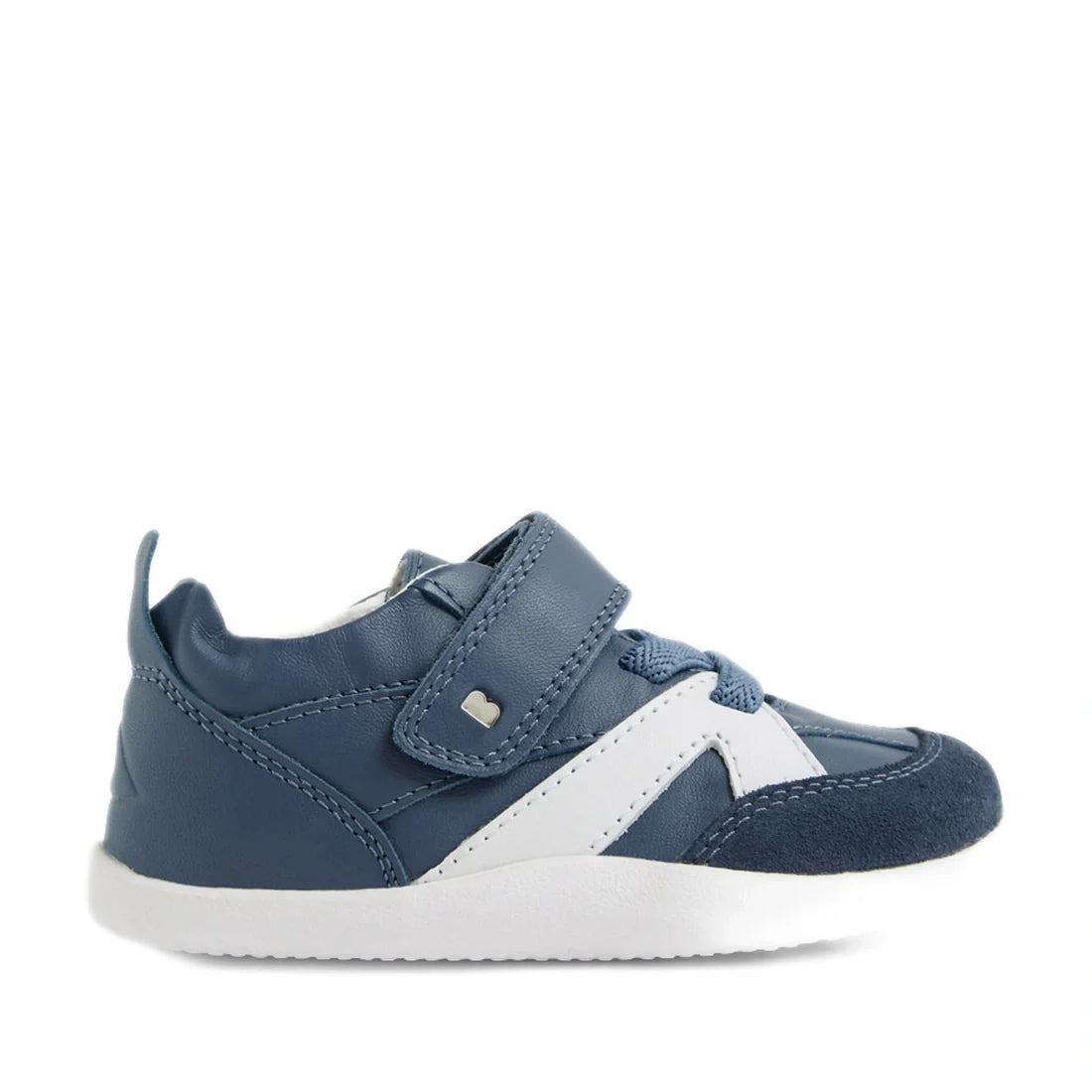 Introducing the Bobux Xplorer XP Chase Vintage Indigo Blue First Walker Crawler—a stylish baby sneaker featuring a blue and white color scheme with a white sole, navy toe cap, and convenient Velcro strap across the top. Perfect for first walkers, this des