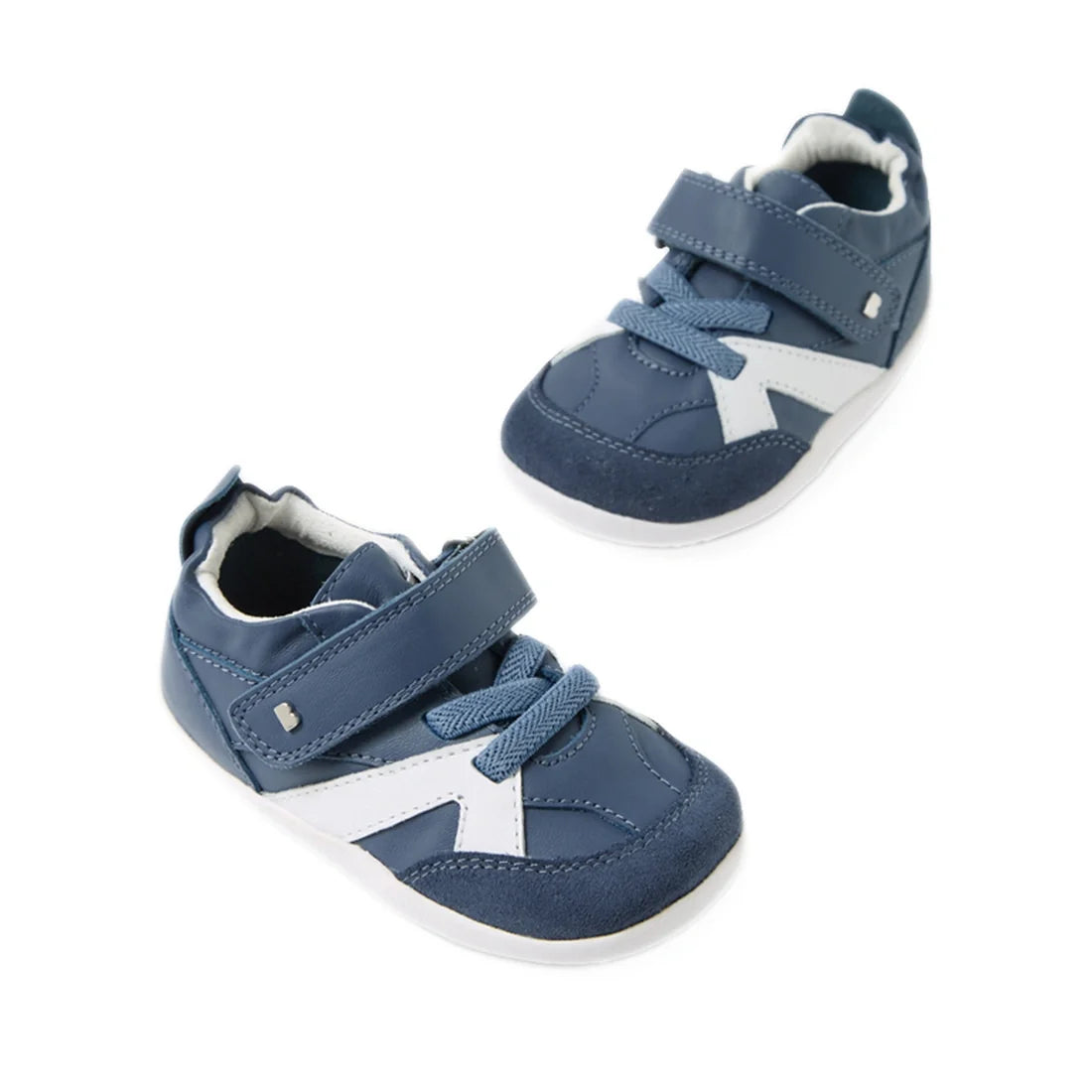 Introducing the Bobux Xplorer XP Chase Vintage Indigo Blue First Walker Crawler: a stylish pair of baby sneakers in blue and white, featuring both velcro straps and laces—perfect for your little one’s first steps, elegantly displayed on a white background