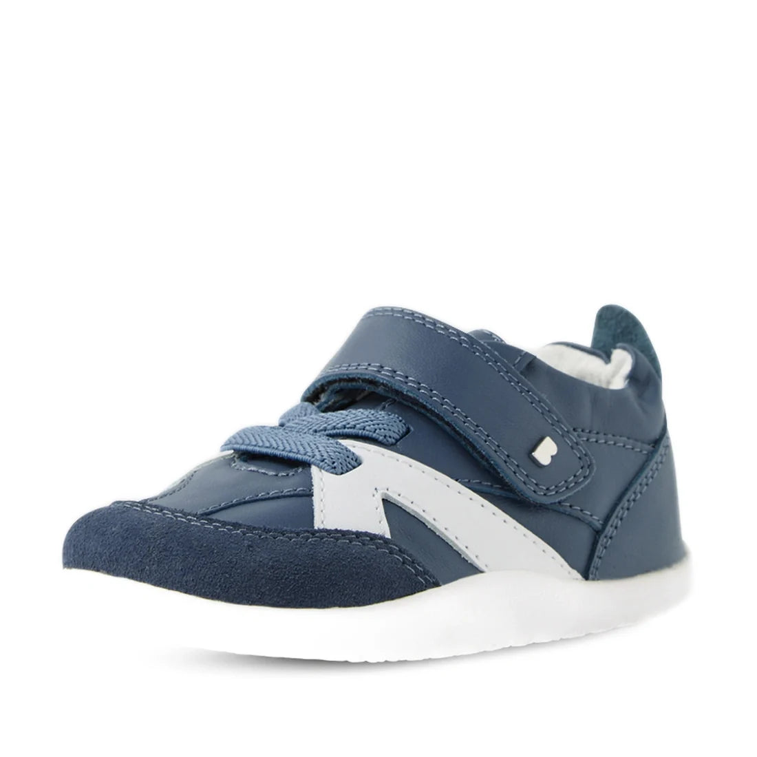 The Bobux Xplorer XP Chase Vintage Indigo Blue First Walker Crawler is pictured at an angle on a plain white background, featuring a blue design with white accents, faux laces, and a velcro strap. Ideal as first walking shoes, it boasts a supportive white