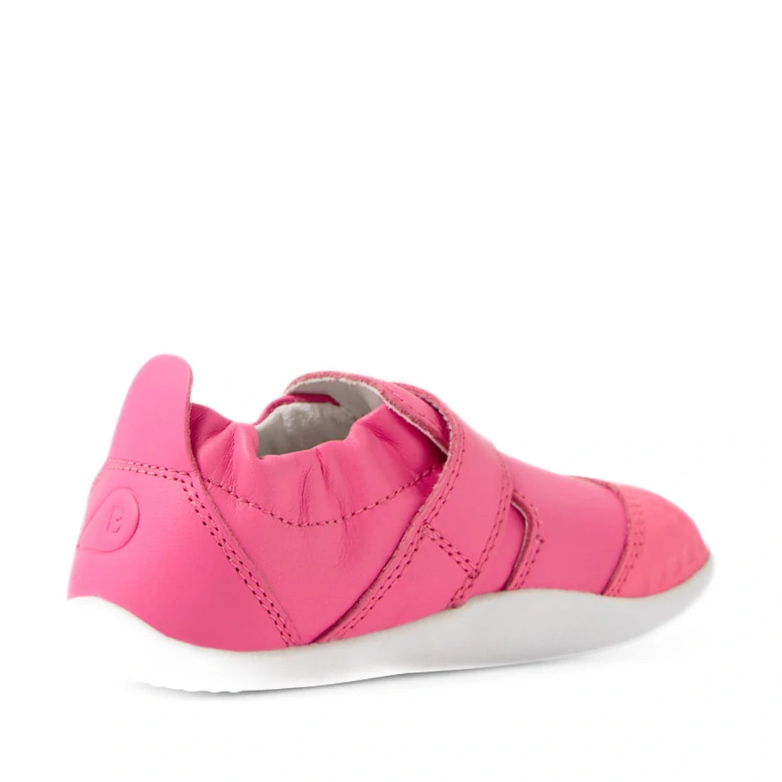 The Bobux Xplorer XP Go Pink Lemonade First Walker Crawler is featured angled backward on a white background, showcasing its pink leather design with a white sole, elastic heel, and velcro strap—perfect as toddler shoes or soft first walker footwear for l