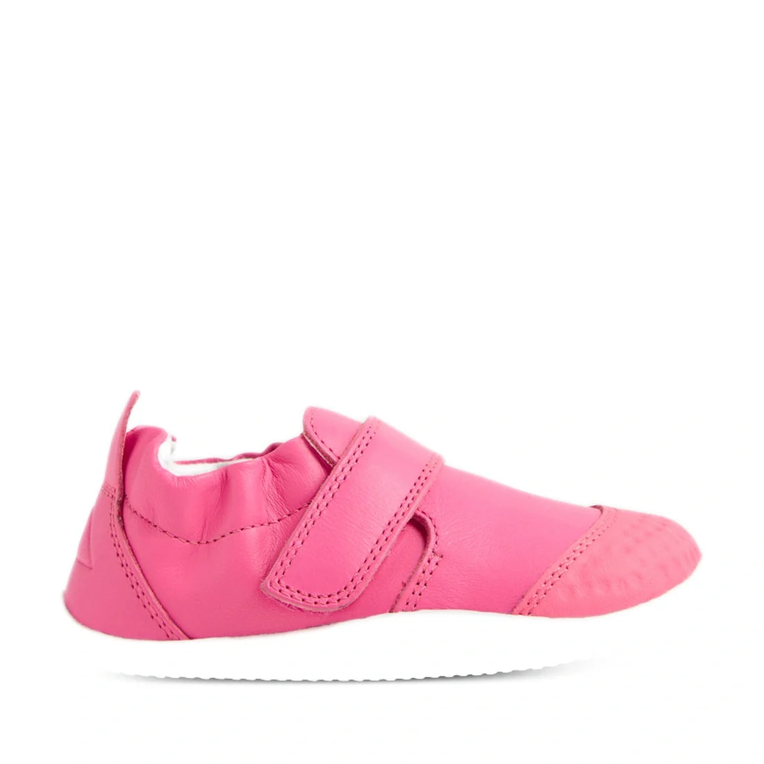 Introducing the Bobux Xplorer XP Go Pink Lemonade First Walker Crawler—a vibrant pink, soft leather baby shoe featuring a Velcro strap, elasticized ankle, and white sole. Shown in a side profile view on a white background, it’s the perfect first walker sh