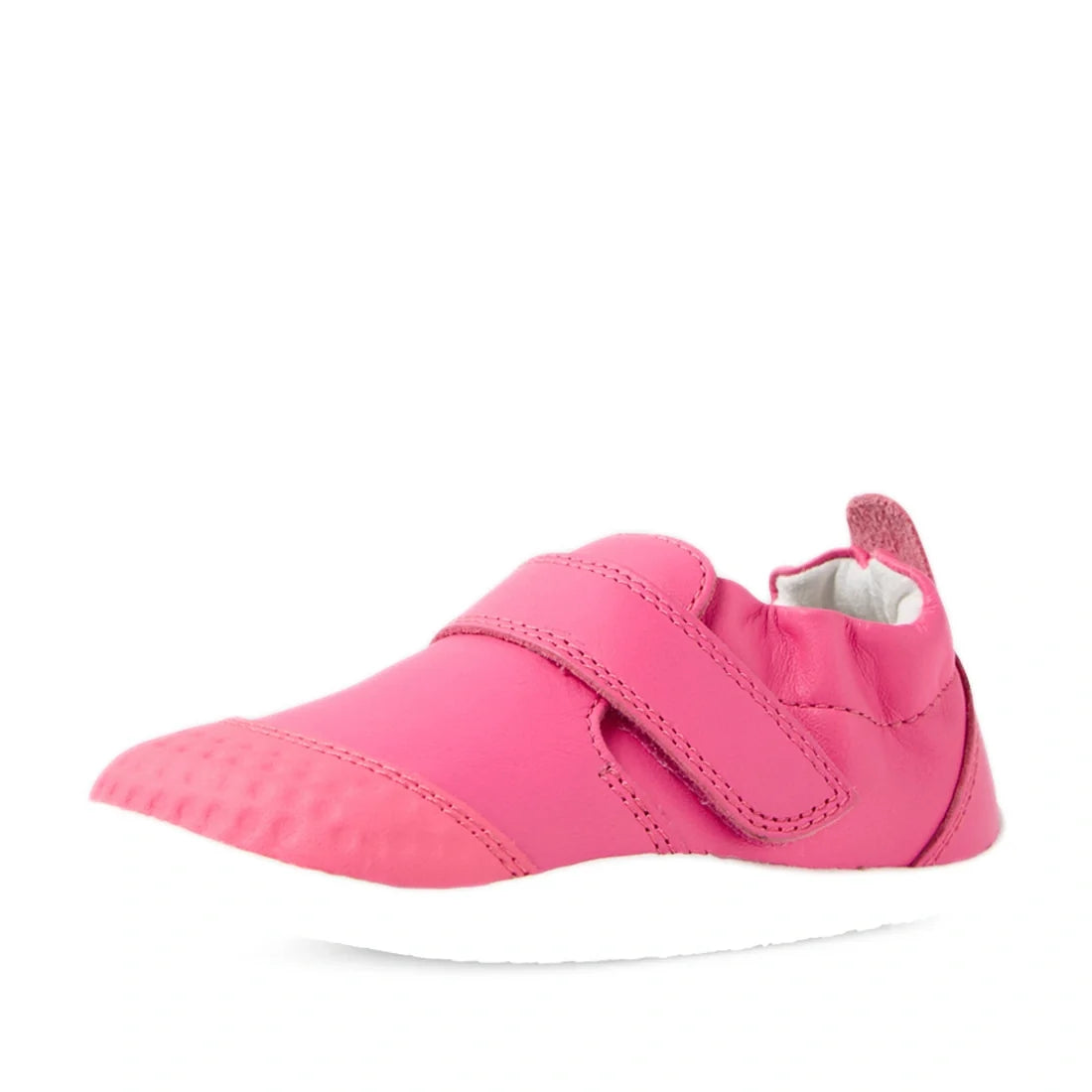 The Bobux Xplorer XP Go Pink Lemonade First Walker Crawler is a soft leather baby shoe in pink with a Velcro strap and a white sole, displayed from a front-side angle on a white background—perfect for toddlers as their first walker shoes., 9420074809032, 