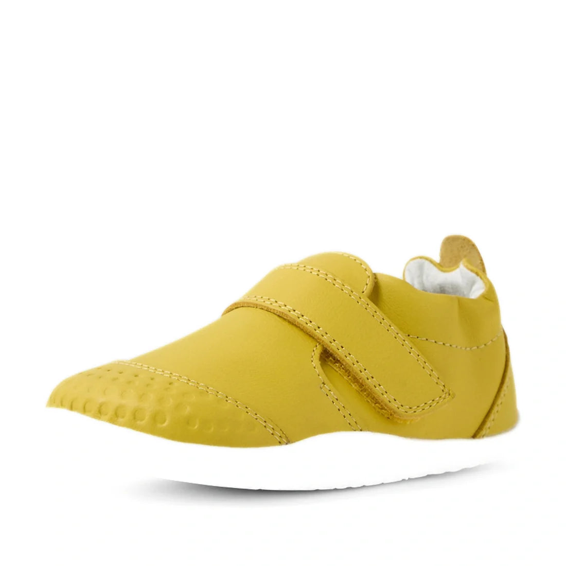 The Bobux Xplorer XP Go Mango Mint First Walker Crawler is a single yellow children’s shoe with a white sole, crafted from soft leather and featuring a hook-and-loop strap and textured toe area for added grip—displayed on a white background., 942007480933