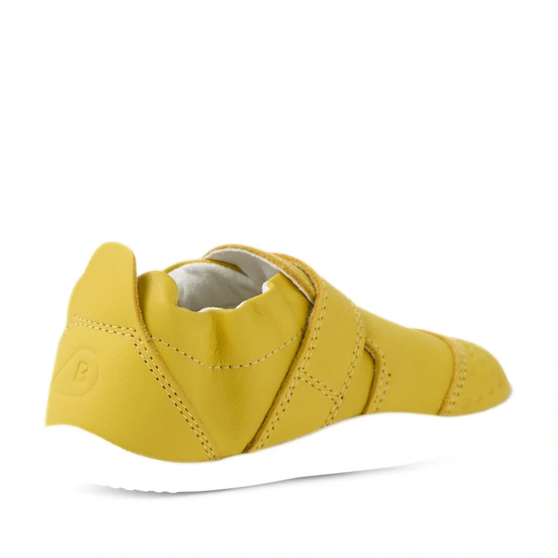 The Bobux Xplorer XP Go Mango Mint First Walker Crawler is a yellow slip-on shoe with a white sole, shown from the back and side at an angle. It features elastic panels and smooth leather material—ideal as soft leather baby shoes or stylish first walkers 