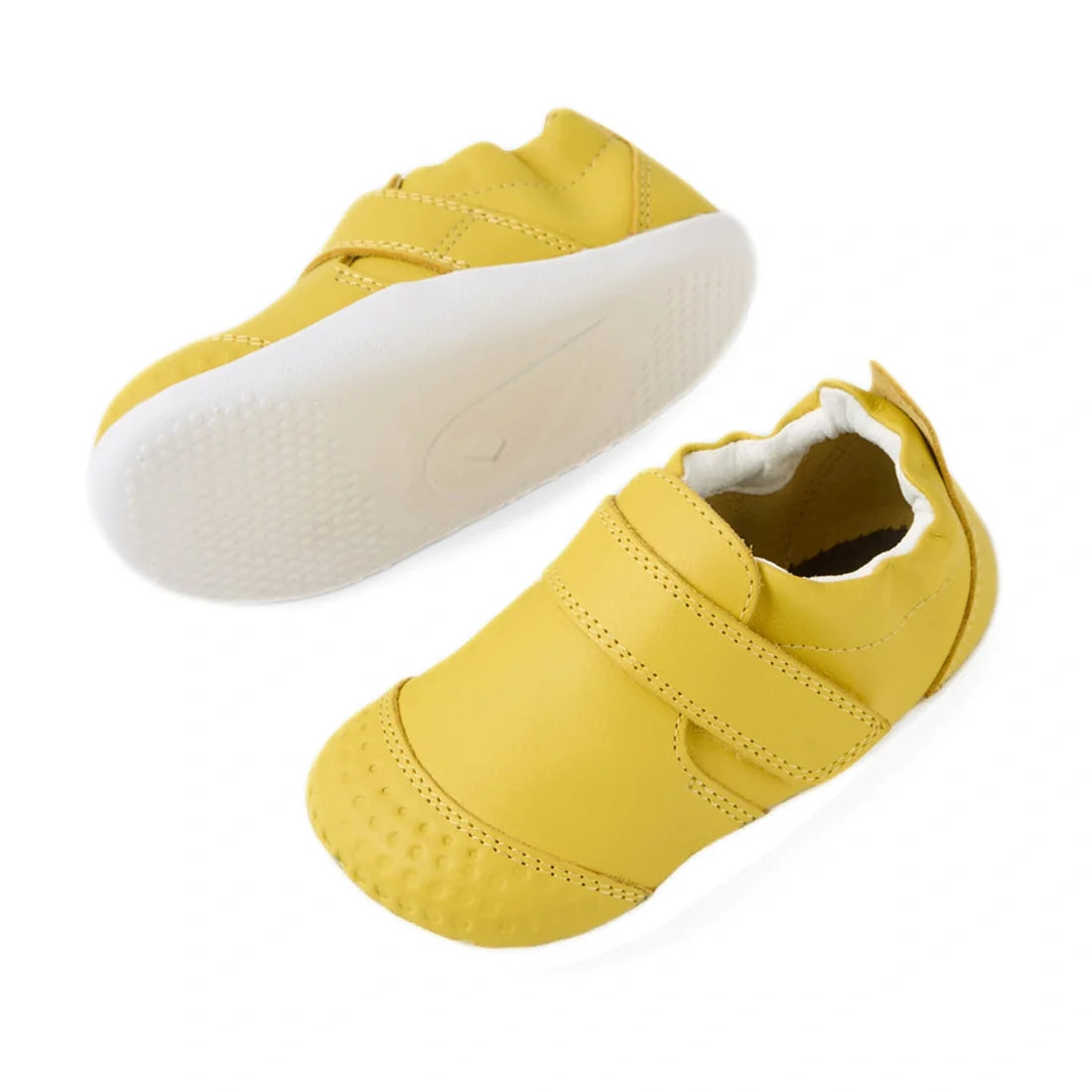 A pair of Bobux Xplorer XP Go Mango Mint First Walker Crawler infant shoes in yellow with white soles, featuring a hook-and-loop strap and textured toe area. One shoe is upright while the other displays the sole., 9420074809339, 9420074809346, 94200748093