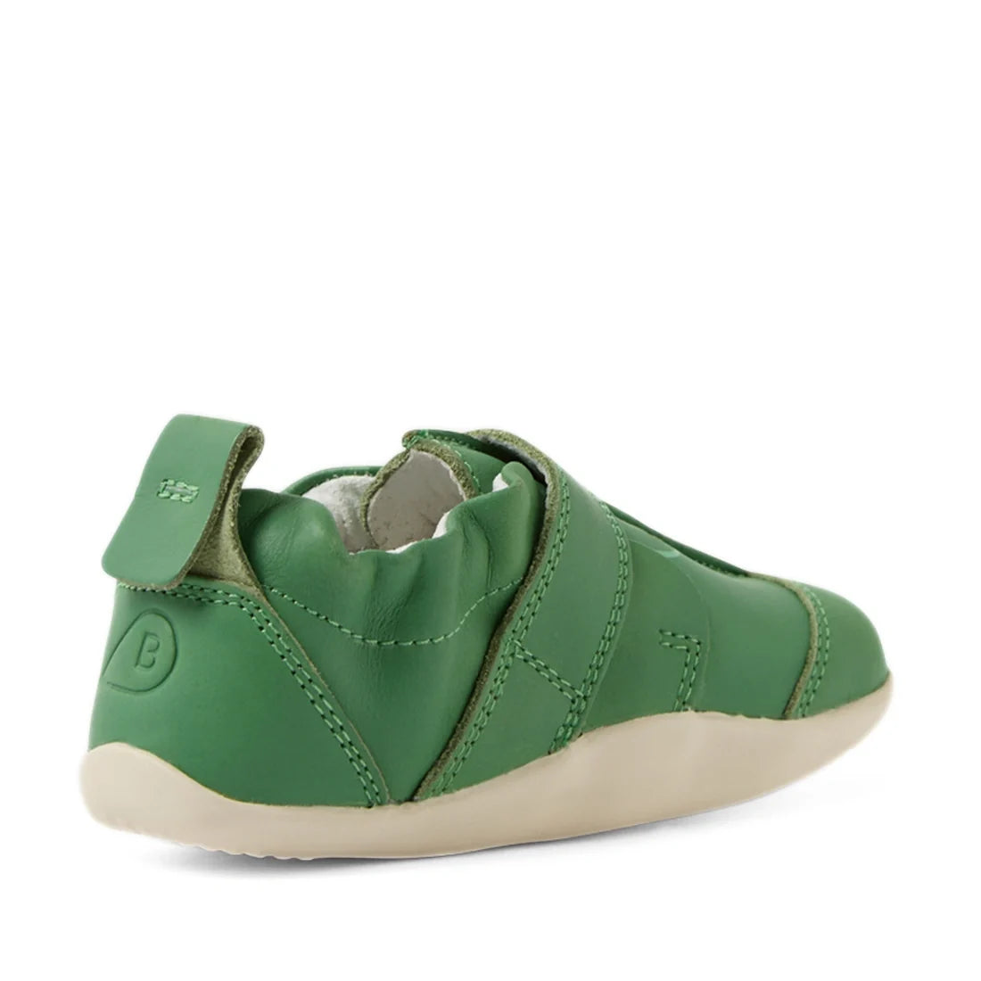 The Bobux XP Explorer Little Sprouts Apple Pomme First Walker Green is a green leather baby shoe with a soft, flexible sole and a convenient pull tab at the heel, photographed to showcase its back and side. This first walking shoe has visible stitching an