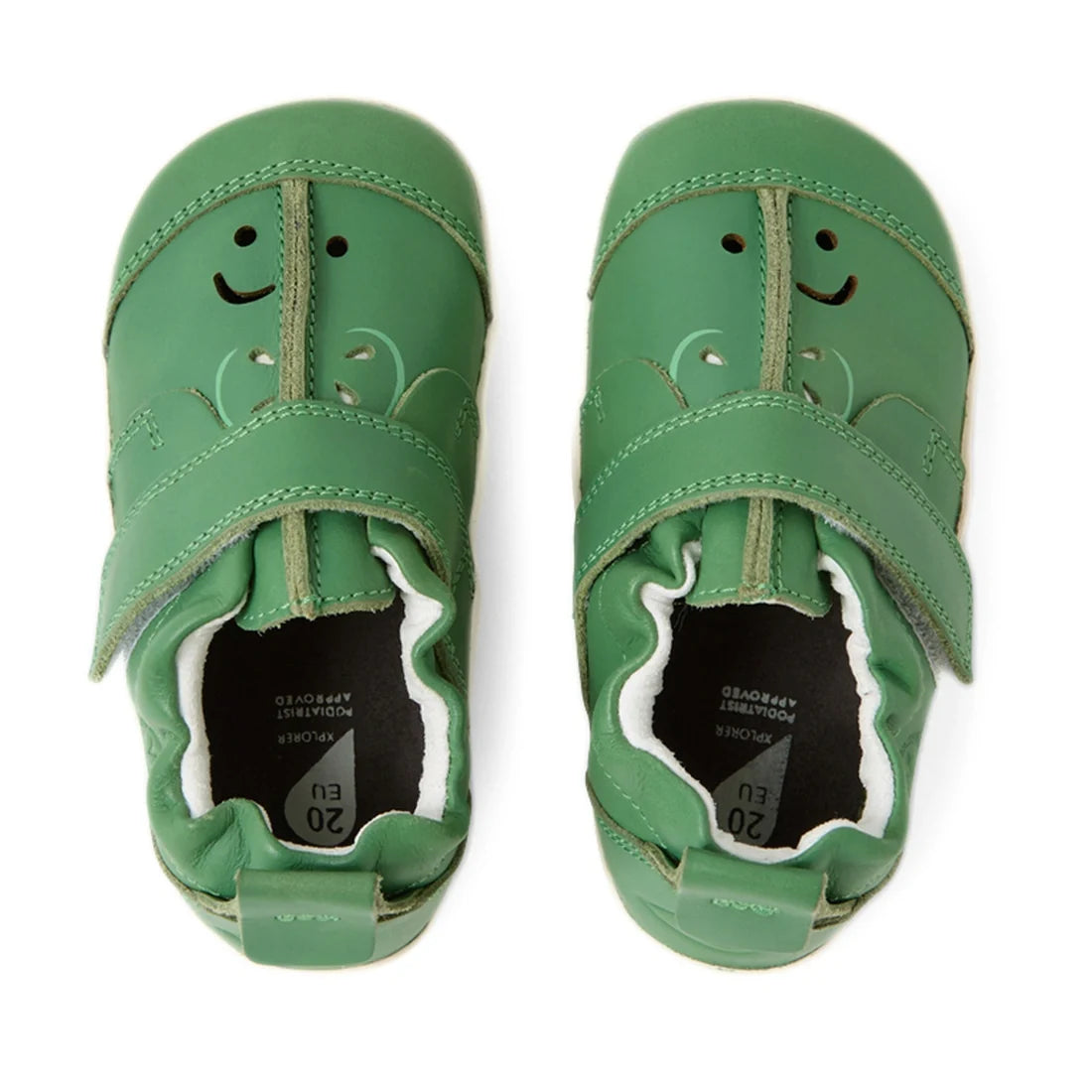 A pair of Bobux XP Explorer Little Sprouts Apple Pomme First Walker Green leather baby shoes with smiley faces and leaf designs on the toes. Designed as ideal first walking shoes, they feature Velcro straps and soft, flexible soles perfect for little pre-