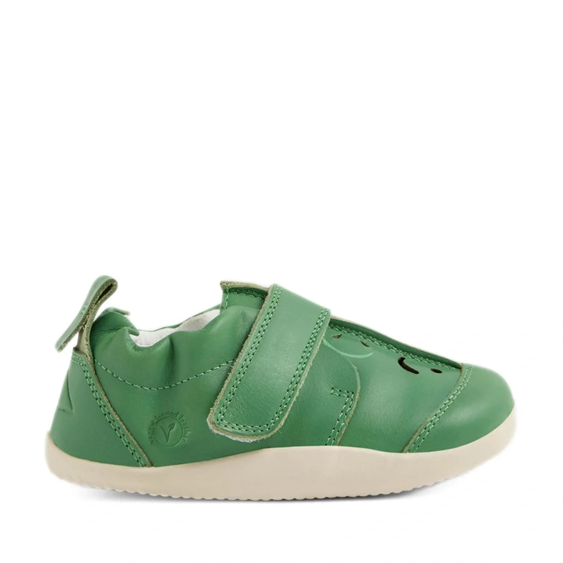 The Bobux XP Explorer Little Sprouts Apple Pomme First Walker Green baby shoe features green leather, a beige sole, a velcro strap, and a pull tab at the back. Shown from the side on a white background, these stylish and comfortable shoes are ideal as fir