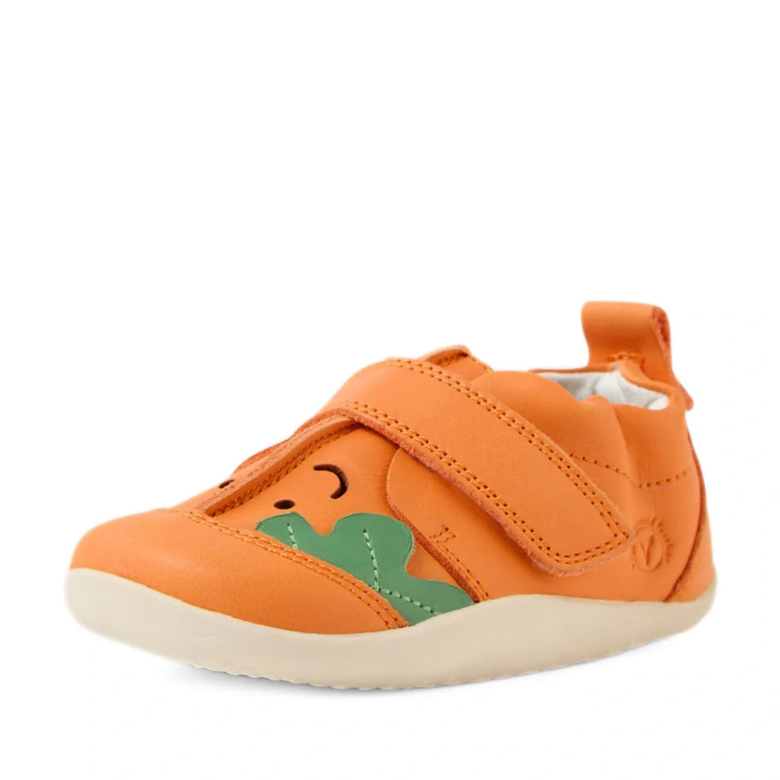 Introducing the Bobux XP Explorer Little Sprouts Carrot Top First Walker Orange – a playful baby shoe designed in vibrant orange with a charming carrot motif, complete with a green leafy accent and a cheerful face. Featuring a secure hook-and-loop strap a