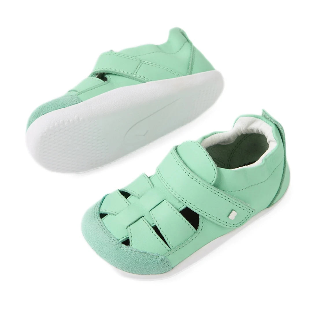 A pair of Bobux XP Explorer Maris First Walker Sandal Jelly Mint baby shoes, crafted in mint green leather with white soles, styled as fisherman sandals—one shoe upright and the other on its side to showcase the strappy pre-walker design and sole., 942007