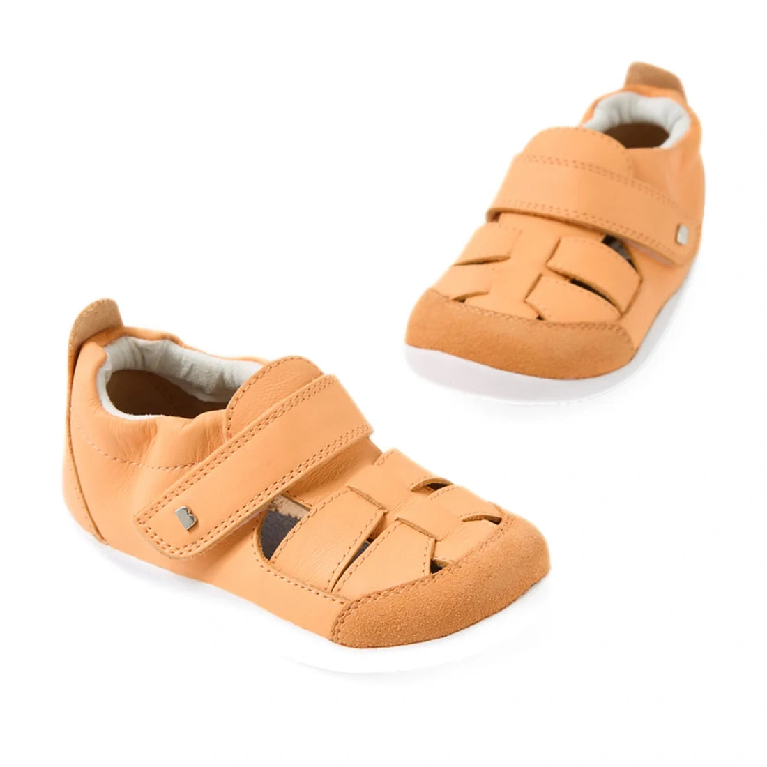 A pair of Bobux XP Explorer Maris First Walker Sandal Peach Jelly toddler sandals featuring light tan coloring, white flexible soles, velcro straps, and woven leather detailing, displayed on a white background.