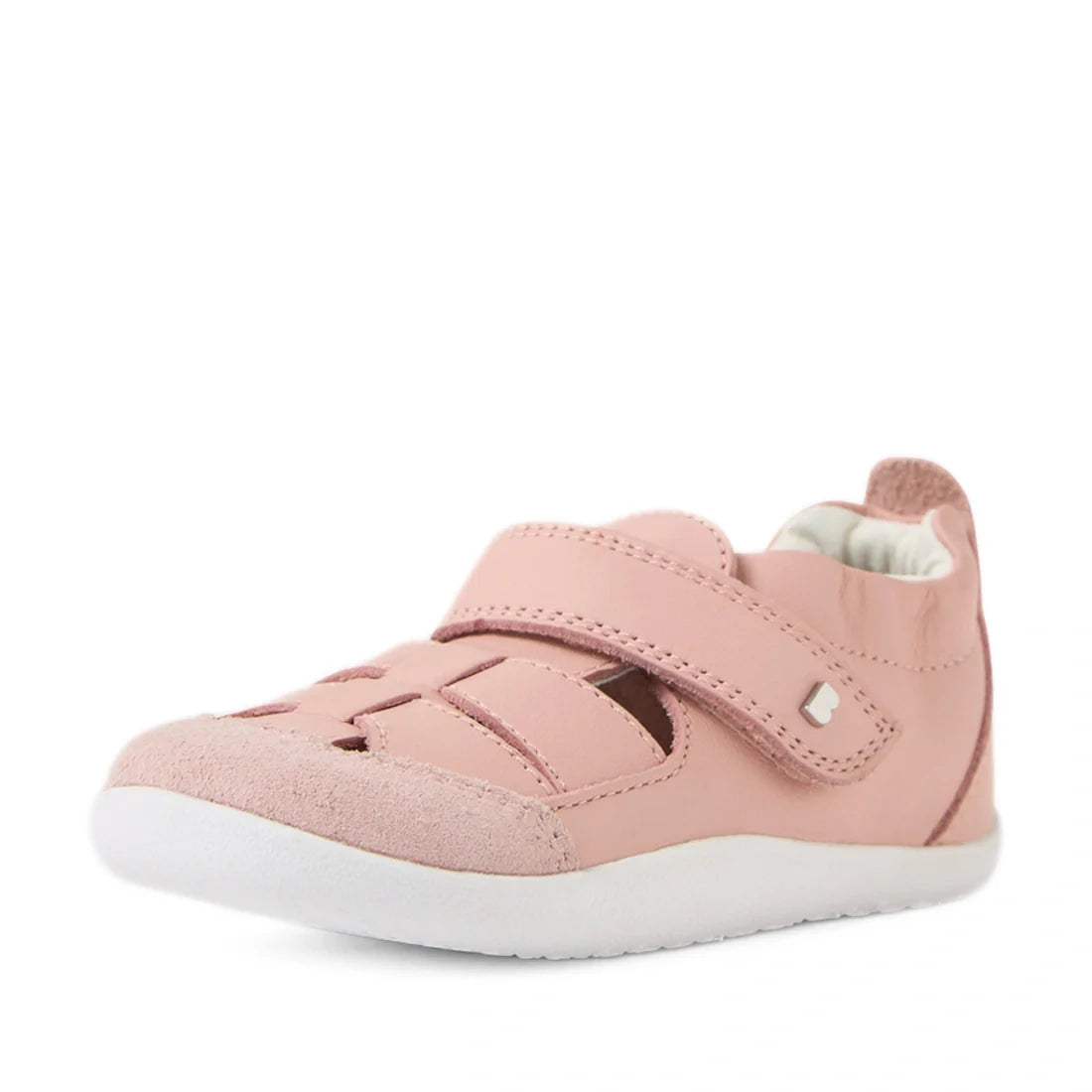 Introducing the Bobux XP Explorer Maris First Walker Sandal in Pink—a soft and flexible pink leather baby shoe with a white sole. Designed with inspiration from classic fisherman sandals, it features a closed toe, hook-and-loop strap, and charming cut-out