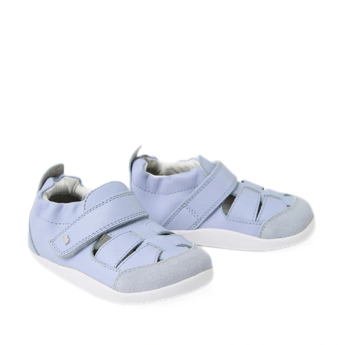Introducing the Bobux XP Explorer Maris First Walker Sandal in Skyway Blue—light blue toddler fisherman sandals featuring white soles and convenient velcro straps. Designed for comfort and support, these flexible leather shoes are perfect for little ones 
