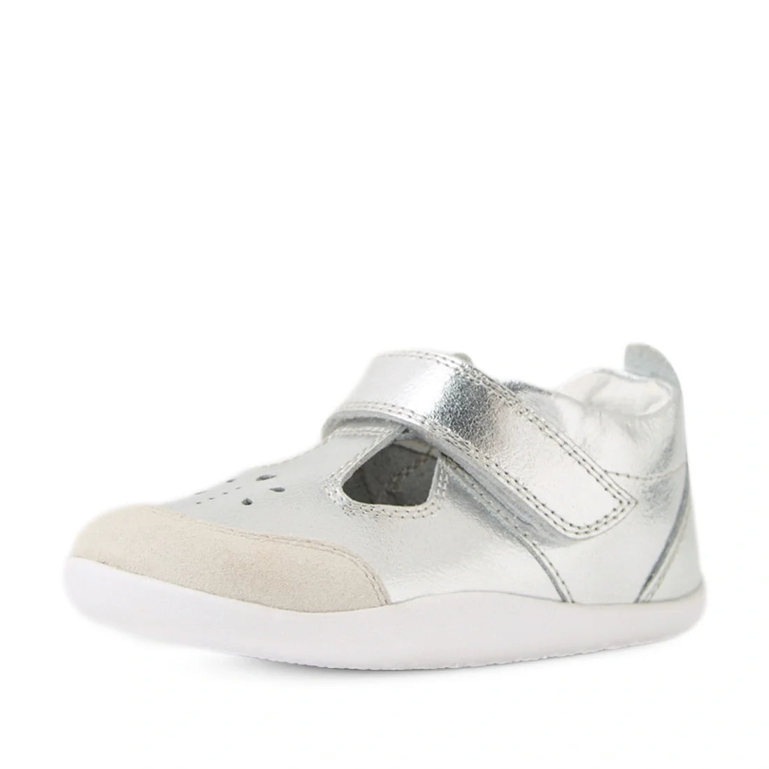 The Bobux XP Explorer Rue First Walker Sandal in Silver is a small toddler shoe featuring a white sole, Velcro strap, and beige suede toe cap. Perfect for first walkers, it boasts a rounded toe and perforated detailing on the front to enhance comfort and 