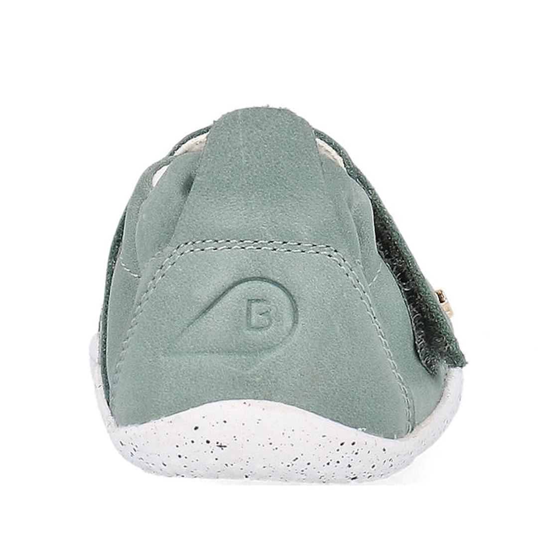 A close-up rear view of the Bobux XP Explorer Beau First Walker Sandal Sage Green 502304, featuring light green suede, a white speckled flexible sole, and a B logo embossed on the heel., 9420075784499, 9420075783676, 9420075783706, 9420075784208