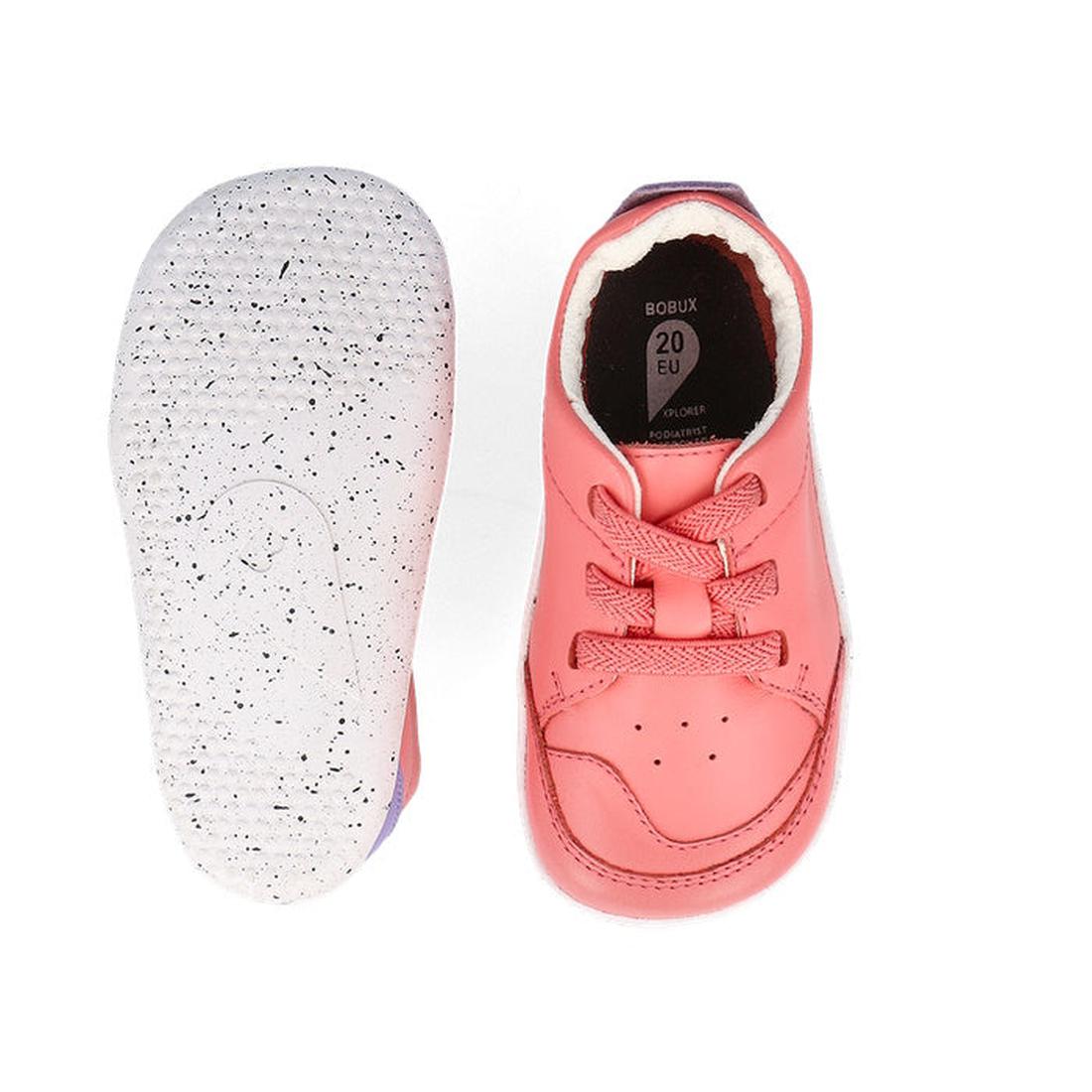 A pair of Bobux XP Explorer Sport First Walker Sneaker Ocean Coral 502204 toddler shoes—one shows pink laces, the other a white, flexible sole with black speckles. The insole reads BOBUX 20 EU. Crafted from premium leather., 9420075785427, 9420075783324, 