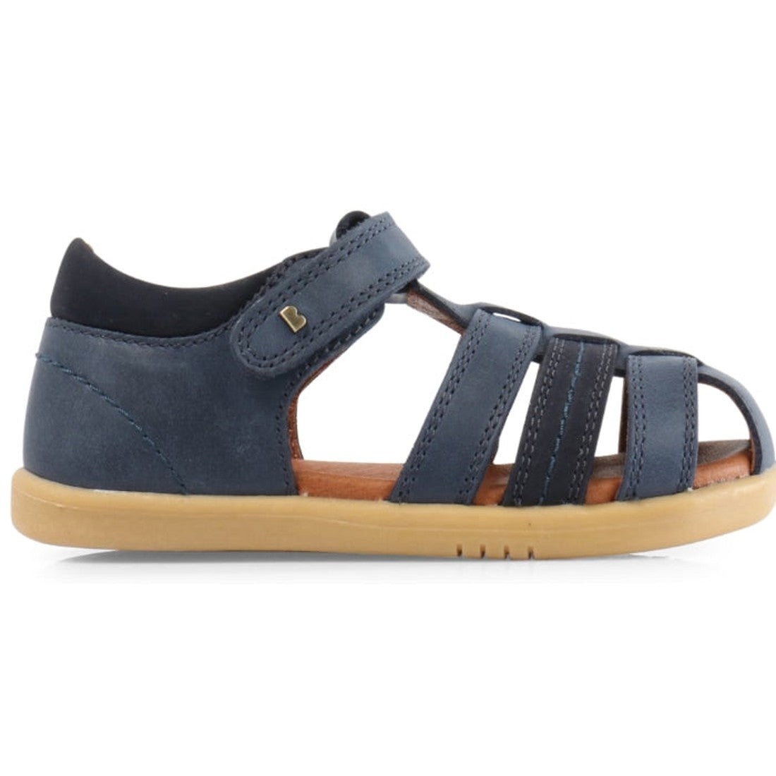The Bobux iwalk Roam Sandal Navy Closed Toe 626008A is a boys' sandal with a navy leather upper, tan rubber sole, velcro strap, closed toe design, multiple front straps, and cushioned ankle collar for comfort., 9420062047279, 9420062047286, 9420057305346,