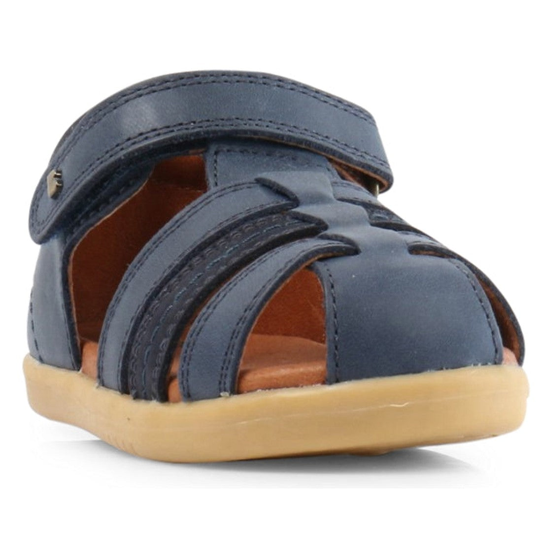 The Bobux iwalk Roam Sandal Navy Closed Toe 626008A is a blue leather summer sandal for children, featuring cutout sides, a velcro strap, light brown rubber sole, and closed toe. Angled slightly from the front left in image., 9420062047279, 9420062047286,