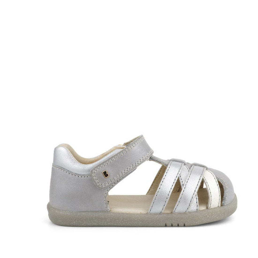 The Bobux iwalk Cross Jump Sandal Silver Pearl Closed Toe 636702 is a children’s silver leather sandal with velcro fastening, open sides, and a flexible rubber sole, shown against a white background., 9420062084045, 9420062084052, 9420062084069, 942006208