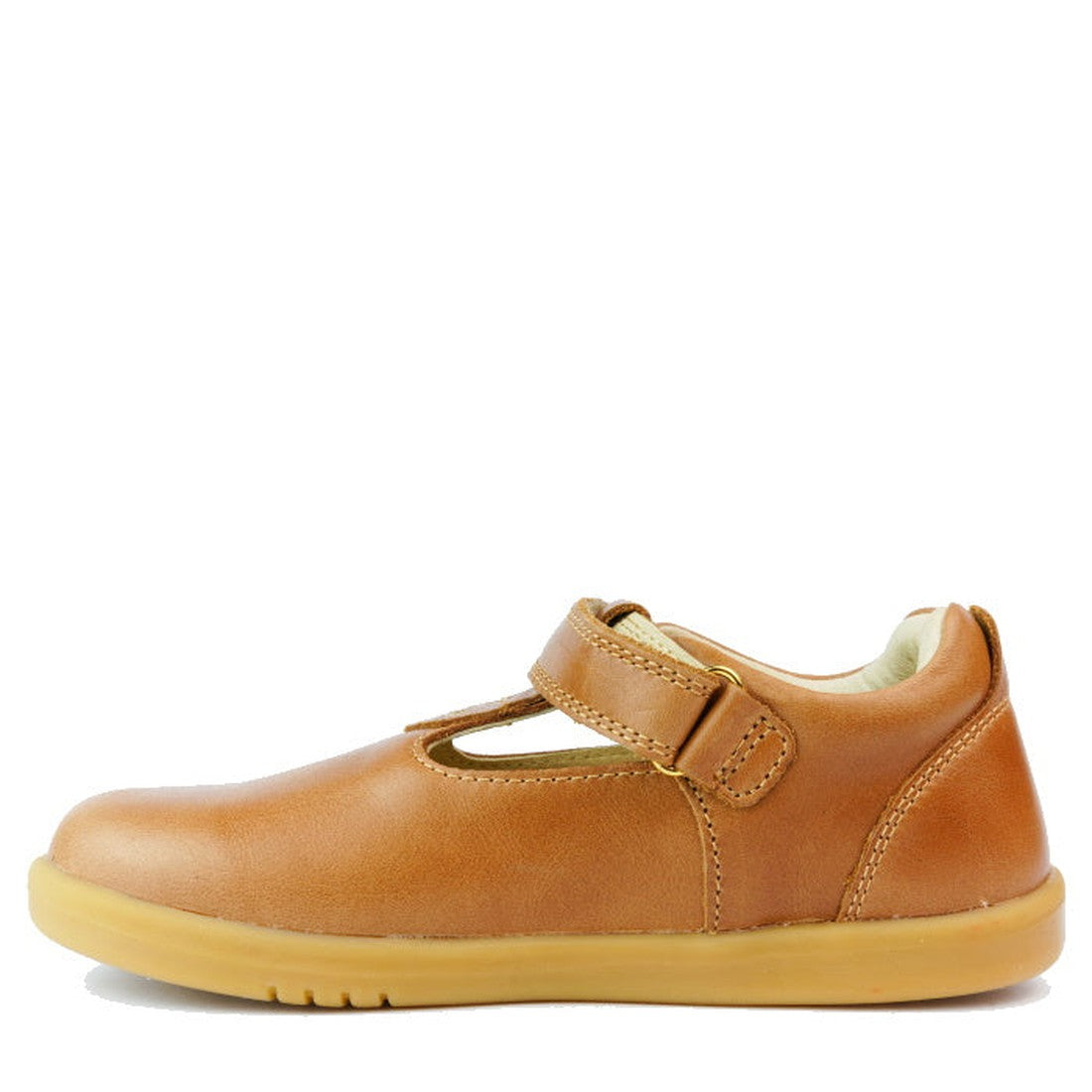 The Bobux Kids Plus KP Louise Caramel Tan T-Bar 833814Z is a brown leather kids’ shoe with a rubber sole, hook-and-loop strap, and classic T-bar cutout design, shown from the side on a white background., 9420068521483, 9420068521490, 9420068521506, 942006