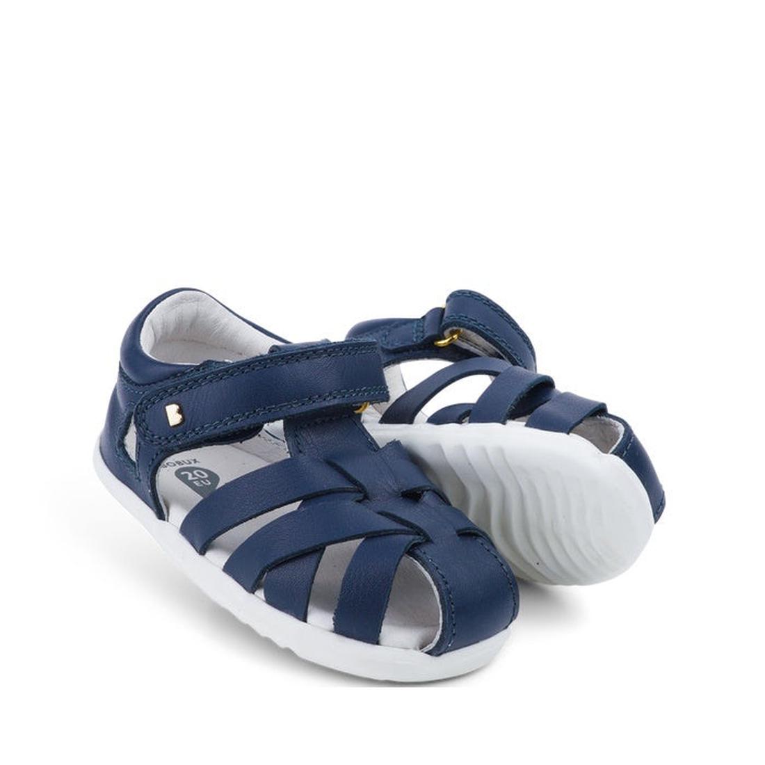 The Bobux Step Up Tropicana II Navy Sandal 732301 Quick Dry features crisscross straps, white soles, adjustable hook-and-loop fasteners, and quick-dry leather—perfect for all-day toddler play.