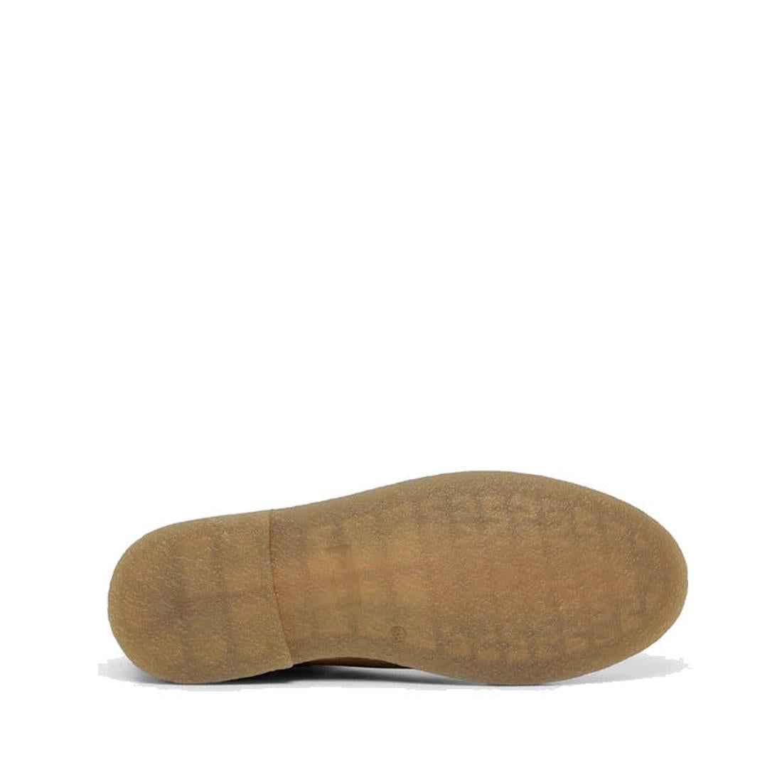 The Clarks Kids Chelsea II Youths Leather Boot in Tan Waxy Leather is shown, featuring a brown rubber sole facing upward against a white background, with a textured tread pattern and advanced Puddle Proof technology., 9336078265111, 9336078265135, 9336078