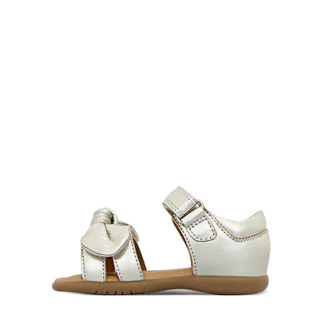 The Clarks Samara Toddlers Gold Leather Sandal in narrow width features an open toe, ankle strap, decorative front bow, tan sole with white stitching, and is shown on a white background., 40541, 9336078235183, 9336078235220, 9336078235268, 9336078235305, 