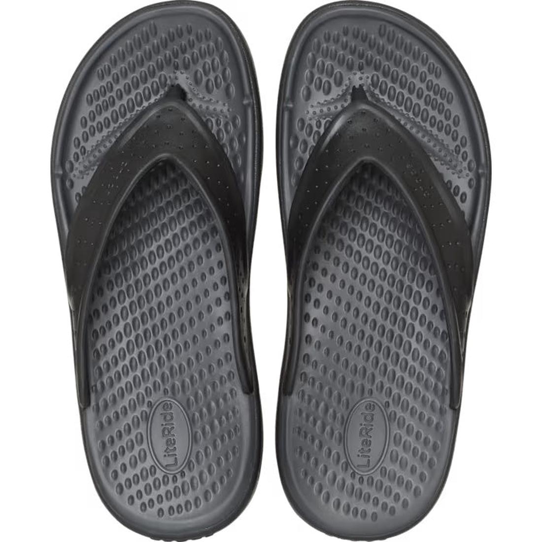 A pair of Crocs - Mens In Motion Flip Flop Jandal in black and grey, viewed from above. They feature textured straps and LiteRide foam footbeds for comfort, labeled LiteRide., 48783, 198445177620, 198445177637, 198445177576, 198445177583, 198445177590, 48