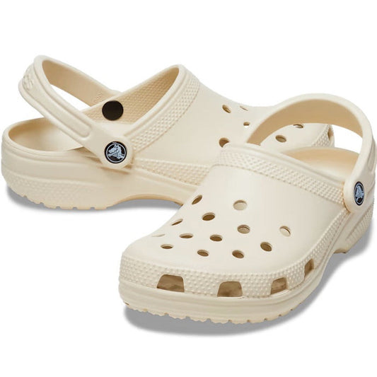 A pair of Crocs - Classic Clog Bone Off White Adults CLEARANCE, featuring ventilation holes, adjustable heel straps, and textured soles, displayed on a white background. Lightweight unisex footwear ideal for everyday comfort.