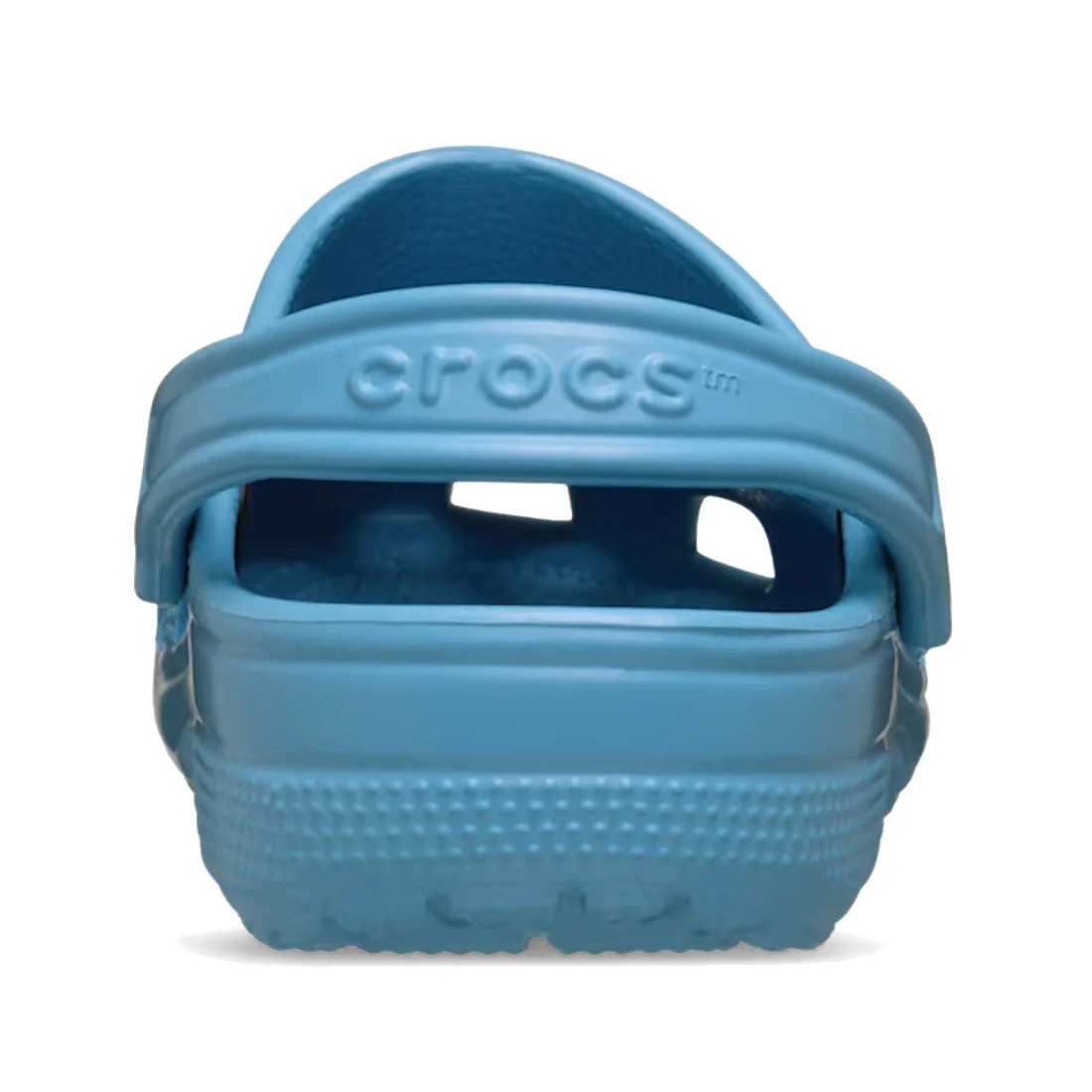 Rear view of a single Crocs Kids - Classic Clog Elite Blue in Junior Youths sizes, with the heel strap raised. The Crocs logo appears on the strap, and the textured, water-friendly sole is visible at the bottom.