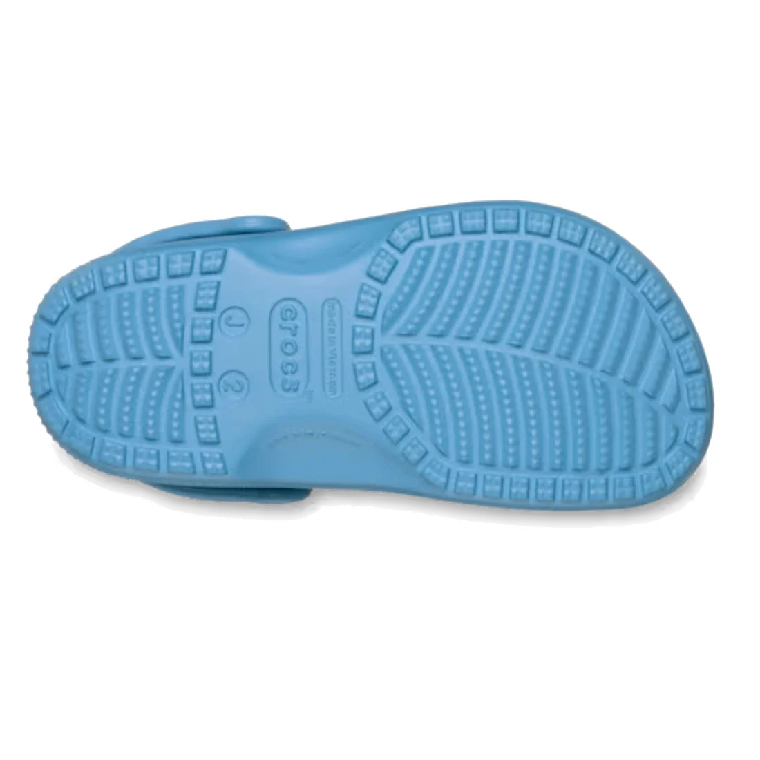 The image displays the sole of a Crocs Kids - Classic Clog Elite Blue (Junior Youths Sizes) shoe, featuring textured treads and an embossed Crocs logo in the center. These water-friendly clogs are designed for comfort and easy wear.