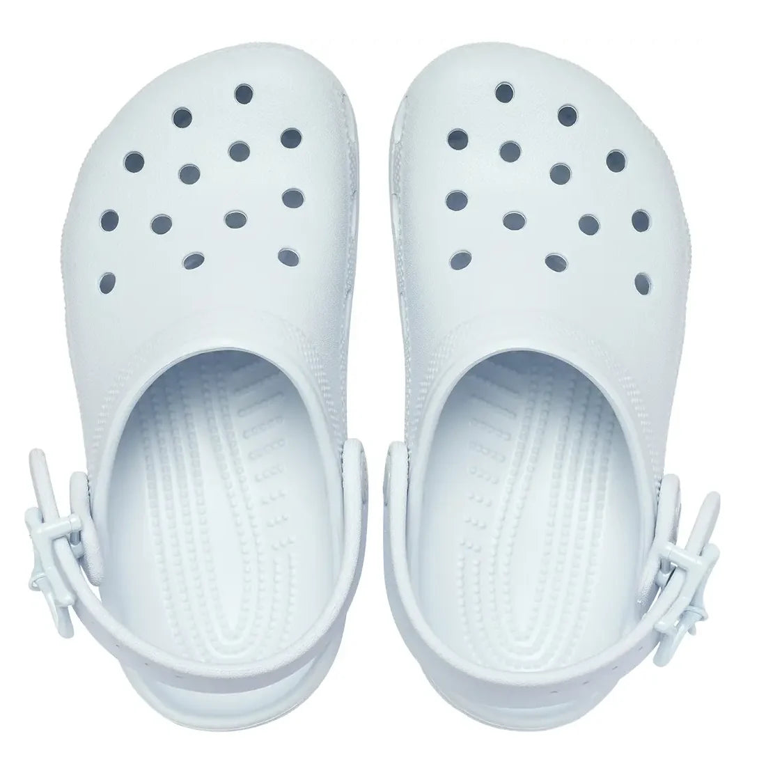 A pair of Crocs Kids - Classic Clog Star Buckle Sky Ice Light Blue Junior Youths Sizes, rubber clogs with ventilation holes on top and adjustable heel straps, viewed from above on a white background; these water-friendly kids clog sandals offer both comfo