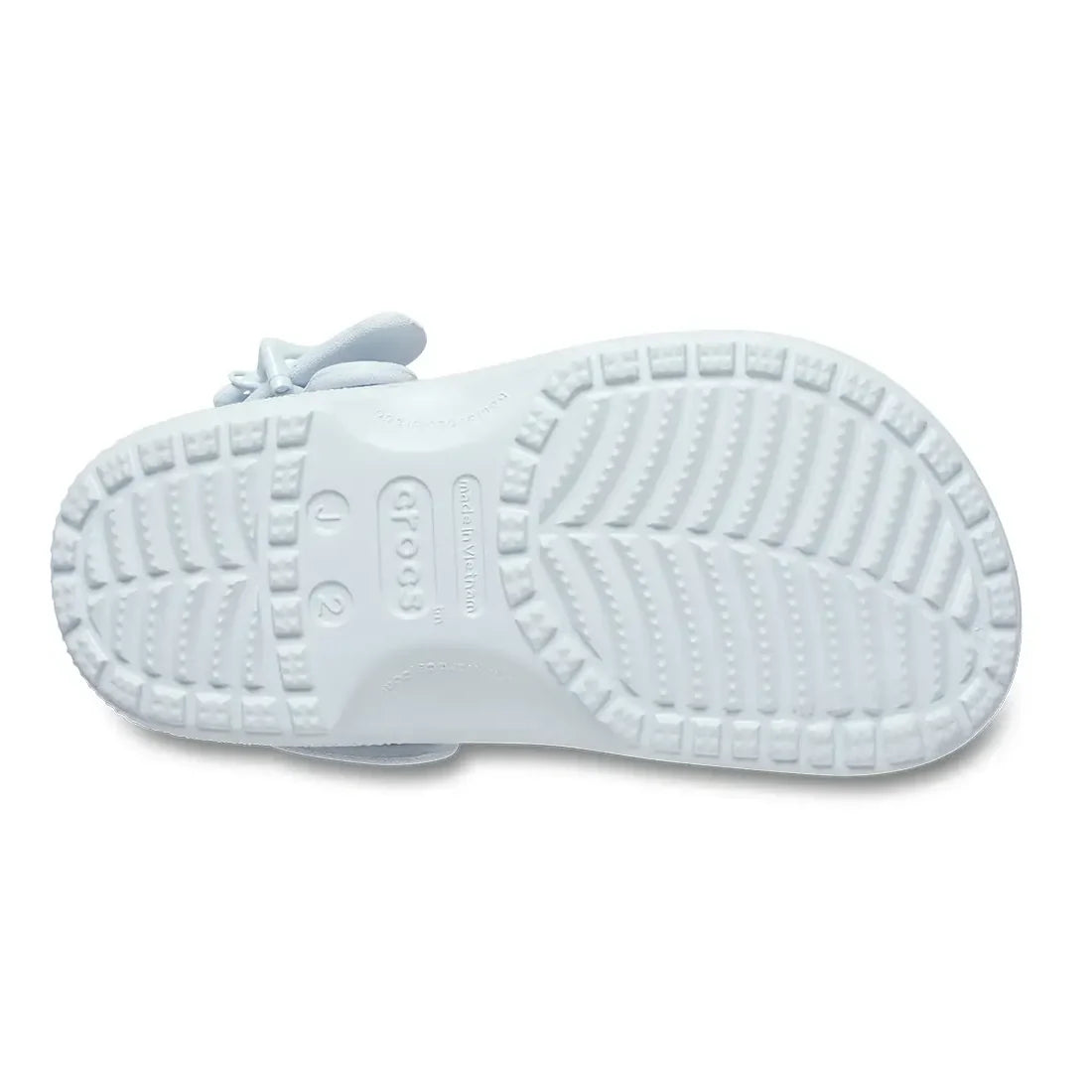 The image shows the sole of a Crocs Kids - Classic Clog Star Buckle Sky Ice Light Blue sandal in junior youths sizes, featuring its patterned tread and brand markings., 53821, 198445516757, 198445516764, 198445516771, 198445516788, 198445516795, 198445516