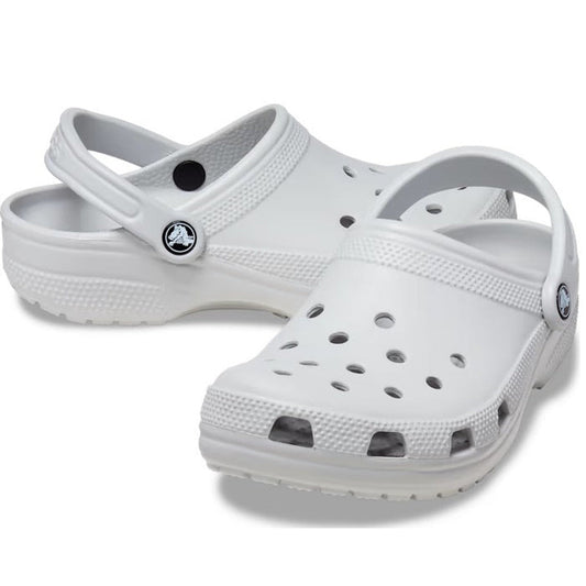 A pair of Crocs - Classic Clog Atmosphere Light Grey Adults, with ventilation holes and a pivoting heel strap, are shown on a plain background for lightweight comfort.