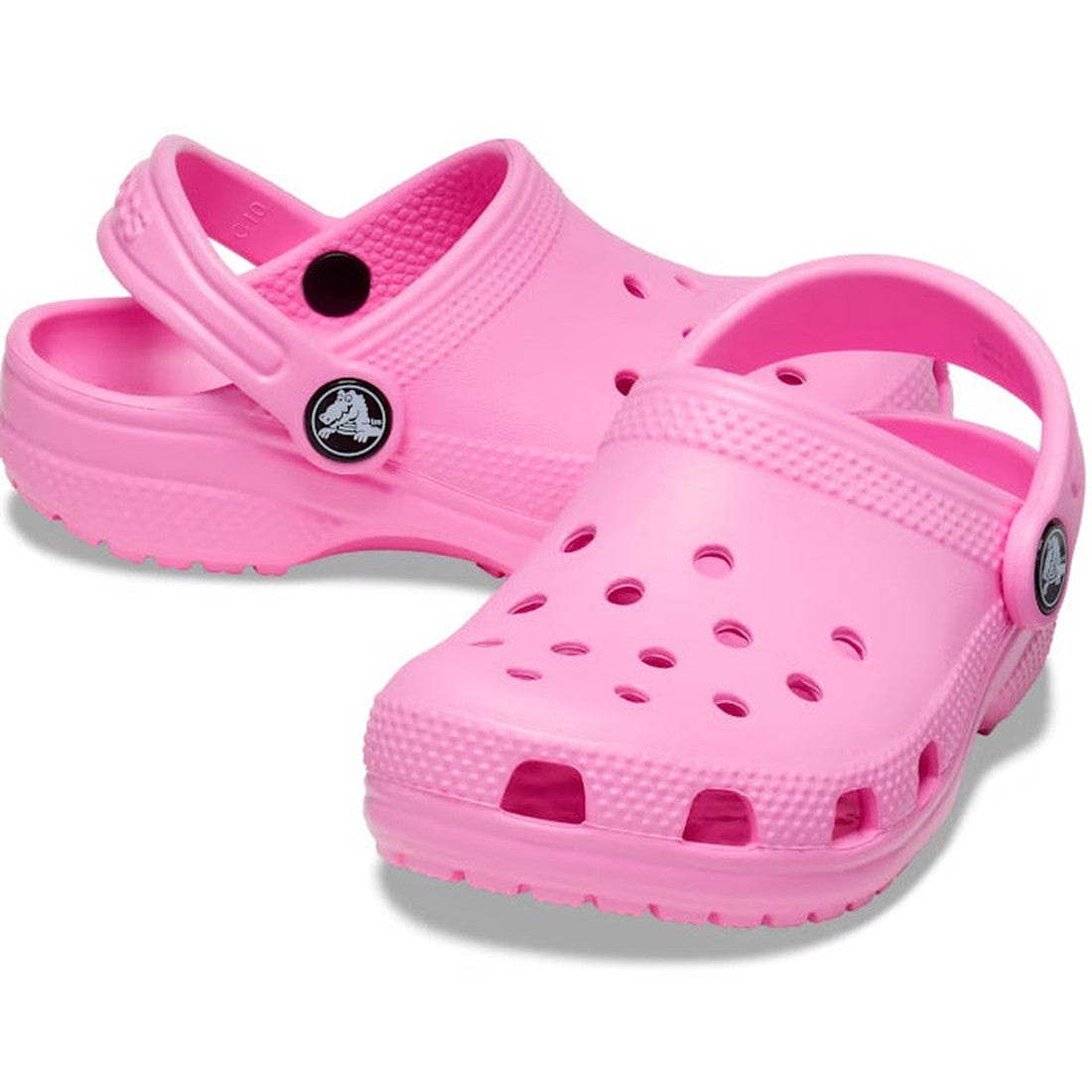 The Crocs Kids Toddlers - Classic Clog K in Taffy Pink features ventilation holes, pivoting heel straps, and a water-friendly design, shown against a white background.