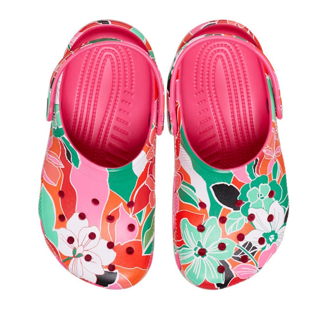 The Crocs Kids Youths - Classic Clog K Woodcut Floral Print in pink features a bold floral pattern with red, green, orange, white, and black accents. Customizable with Jibbitz charms and made for lasting Crocs Comfort., 196265878680, 196265878697, 1962658