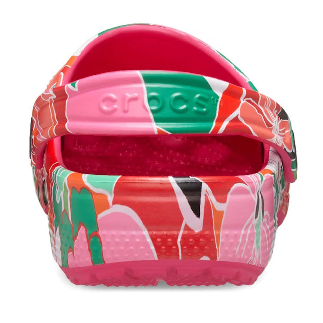 A close-up rear view of the Crocs Kids Youths - Classic Clog K Woodcut Floral Print shows a vibrant floral design, raised strap with Crocs logo, and space for Jibbitz charms—perfect for customization and fun., 196265878680, 196265878697, 196265878703, 196