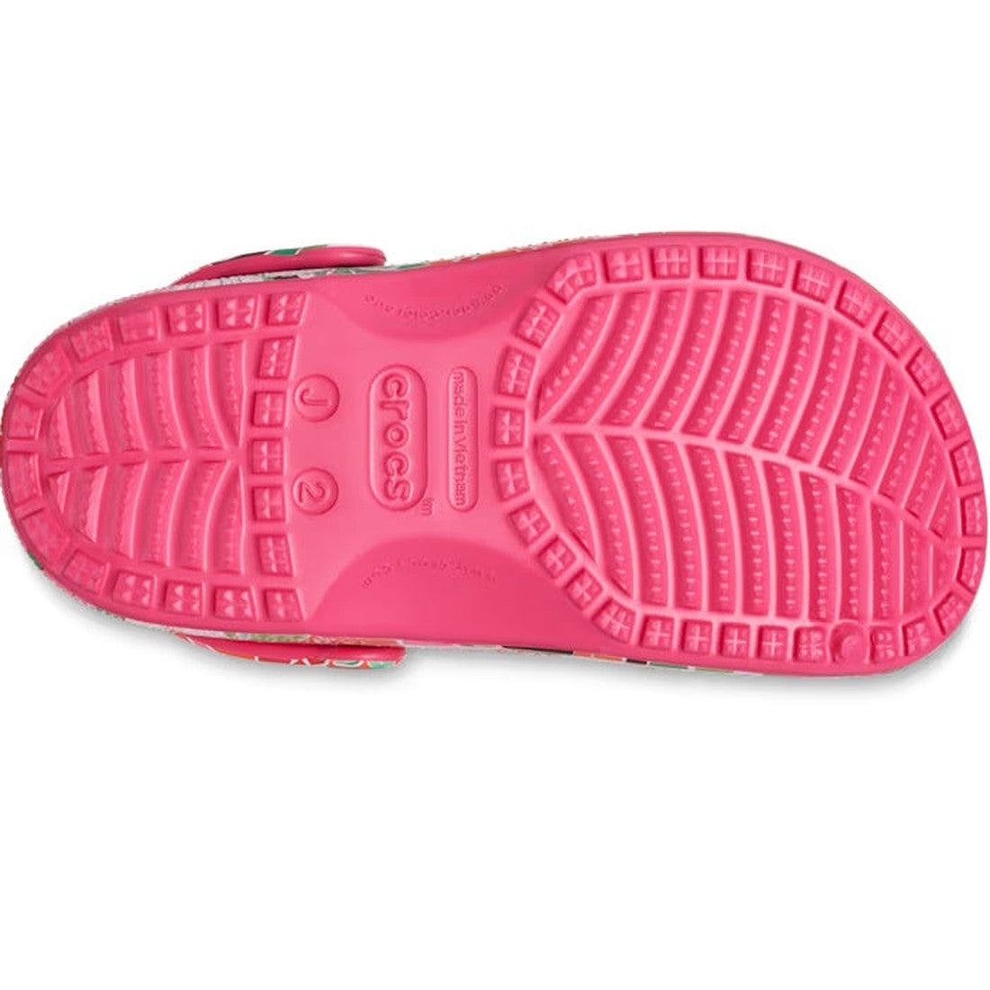 The image shows the sole of the Crocs Kids Youths - Classic Clog K Woodcut Floral Print, with a textured tread, embossed branding, Crocs Comfort, size markers J2 and 2, and holes for Jibbitz charms for added customization., 196265878680, 196265878697, 196