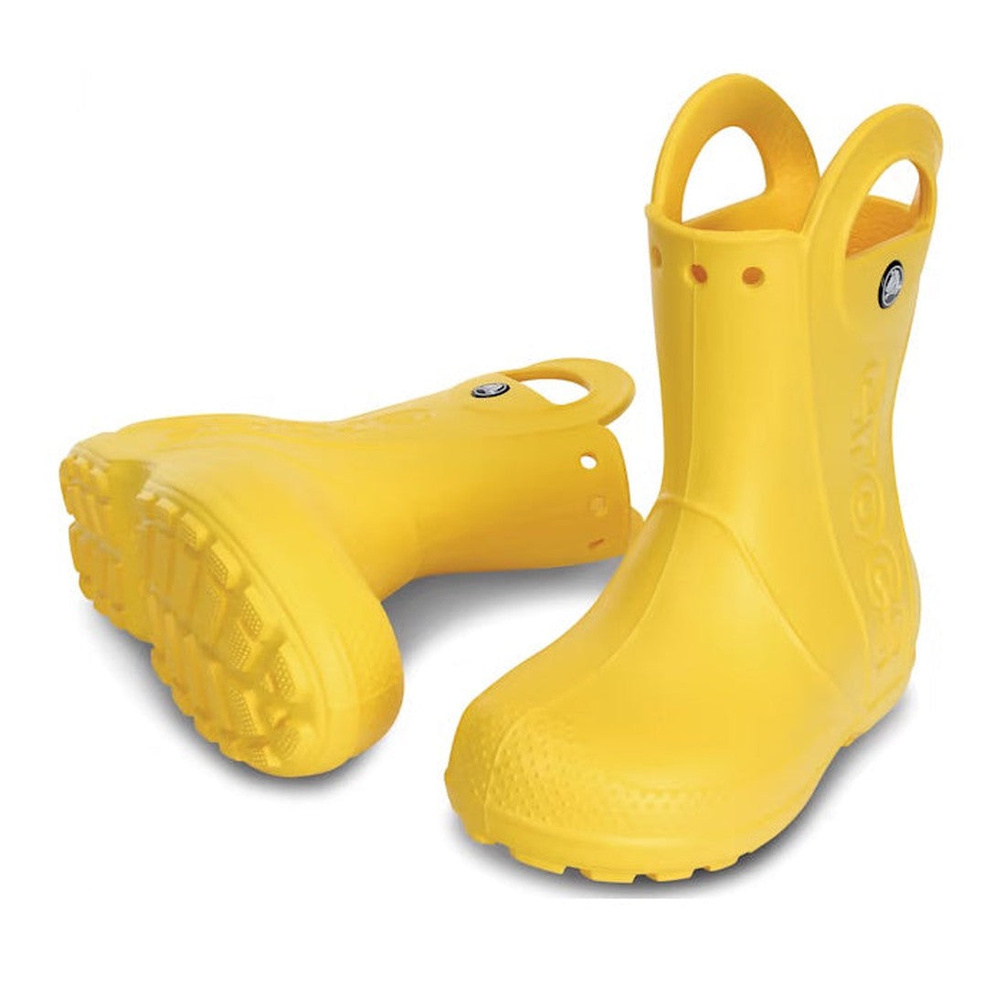 A pair of Crocs Kids Handle It Rain Boot Yellow gumboots for kids, waterproof with handles—one upright, one on its side displaying the textured sole.