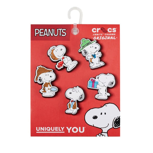 The Crocs Jibbitz 5 Pack - Peanuts Snoopy features five charms of Snoopy in various outfits on a red card with Peanuts and Crocs logos, plus "UNIQUELY YOU" at the bottom.