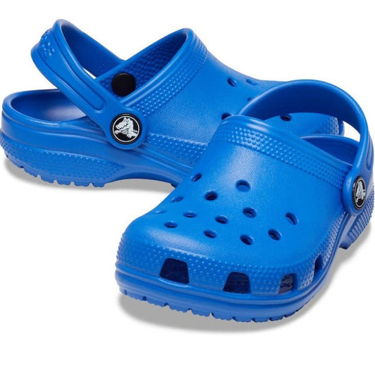 A pair of Crocs Kids Classic Clog Blue Bolt for junior youths, featuring ventilation holes and adjustable heel straps, water-friendly and displayed with one shoe slightly overlapping the other on a white background.